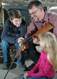 Dad teaching his kids about gun safety